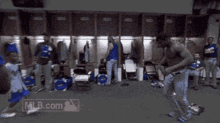 a group of baseball players in a locker room with mlb.com on the bottom left