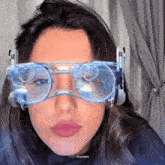 a close up of a woman wearing a pair of glasses that say zeudgifs on the bottom right