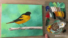 a painting of a bird on a branch next to a palette that says made in animotica