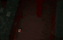 a person is standing in a doorway with a red light behind them holding a knife .
