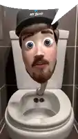 a man with a beard is sitting on a toilet with his head sticking out of the bowl .