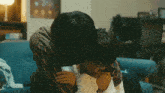 a man and a woman are hugging each other on a couch
