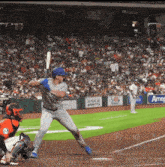 a baseball game is being played in front of a crowd with a sign that says ameg