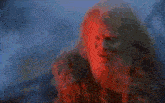 a close up of a person 's face with a red background