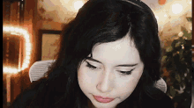 a close up of a woman 's face with a slight smile on her face