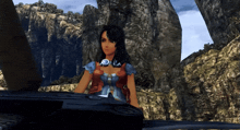 a woman in a video game is sitting in front of a cliff
