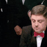 a man in a suit playing a large gong