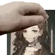 a hand is holding a picture of a girl with a headset on .
