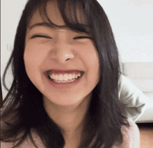 a close up of a woman 's face with a smile on her face
