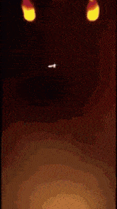 a person is standing in a dark room with flames coming out of them