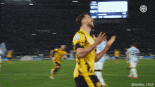 a soccer player wearing a yellow jersey with the number 8 on it