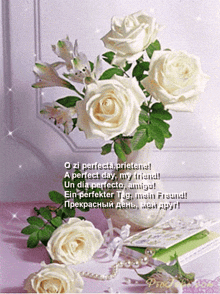 a bouquet of white roses in a vase with a greeting card