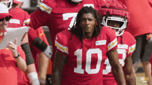 a football player in a red jersey with the number 10 on it