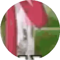 a circle with a red roof and a white building in it