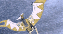 a yellow and white dragon is flying over the water
