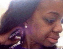 a woman is talking on a cell phone while wearing earrings .