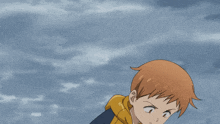 a boy in a blue and yellow jacket with buttons on the sleeves