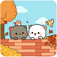 two cats are sitting on a brick wall with a bird sitting on top of one of them .