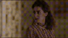 a woman in a plaid shirt is looking at something