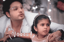 a man and a little girl are sitting next to each other with the words noooo written in white