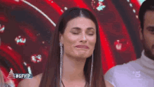 a woman is making a funny face in front of a screen that says #gfvip .