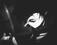 a man smoking a cigarette in a dark room
