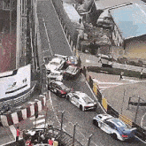 a few cars are driving down a street with a sign that says fia