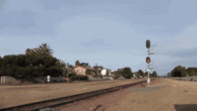 a train is going down the tracks with a red light