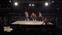 two men in a wrestling ring with the words nwa on the bottom left