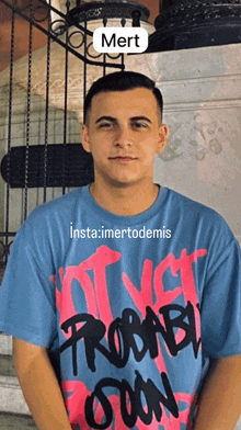 a man wearing a blue and pink probably soon t-shirt
