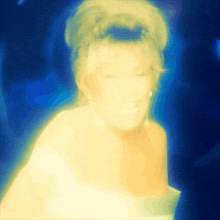 a blurry picture of a woman 's face with blue background
