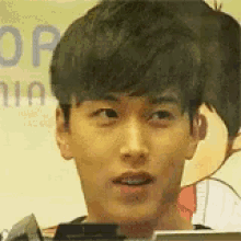 a close up of a man 's face with a cartoon in the background .