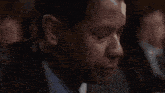 a man in a suit is drinking a glass of water with the words god help me written below him