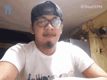 a man wearing glasses and a hat with the hashtag deafeph on the bottom