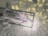 a person is laying on a bed with a light coming out of it