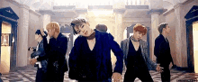 a group of young men are dancing together in a room .