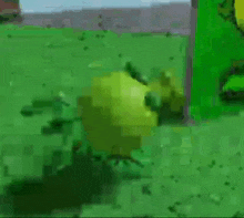 a green cartoon character is standing in a field .