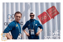 two youth olympic games game changers stand in front of a white wall