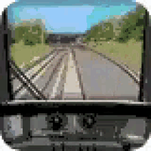a train is going down the tracks with a view of the tracks from the driver 's seat .
