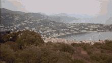 a large body of water surrounded by mountains with boats in it