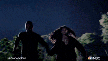 a man and a woman are running through a foggy area with the hashtag #chicagofire
