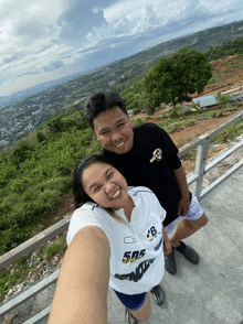 a man and a woman are posing for a picture and the woman is wearing a shirt that says 505 on it