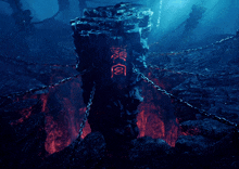 a pillar with chinese writing on it is surrounded by chains in the water