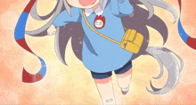 a little girl wearing a blue shirt and shorts has a badge on her chest that says ' たま '