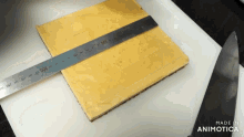 a metal ruler is being used to measure a piece of cake