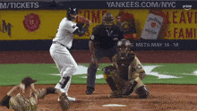 a baseball game is being played in front of a yankees.com/nyc banner