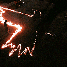 a person is standing in the middle of a circle of flames with the word win written in the middle