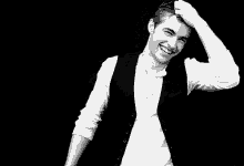 a black and white photo of a smiling man