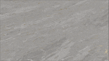 a close up of a gray surface with a few lines of gold
