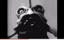 a black and white photo of a monster 's mouth